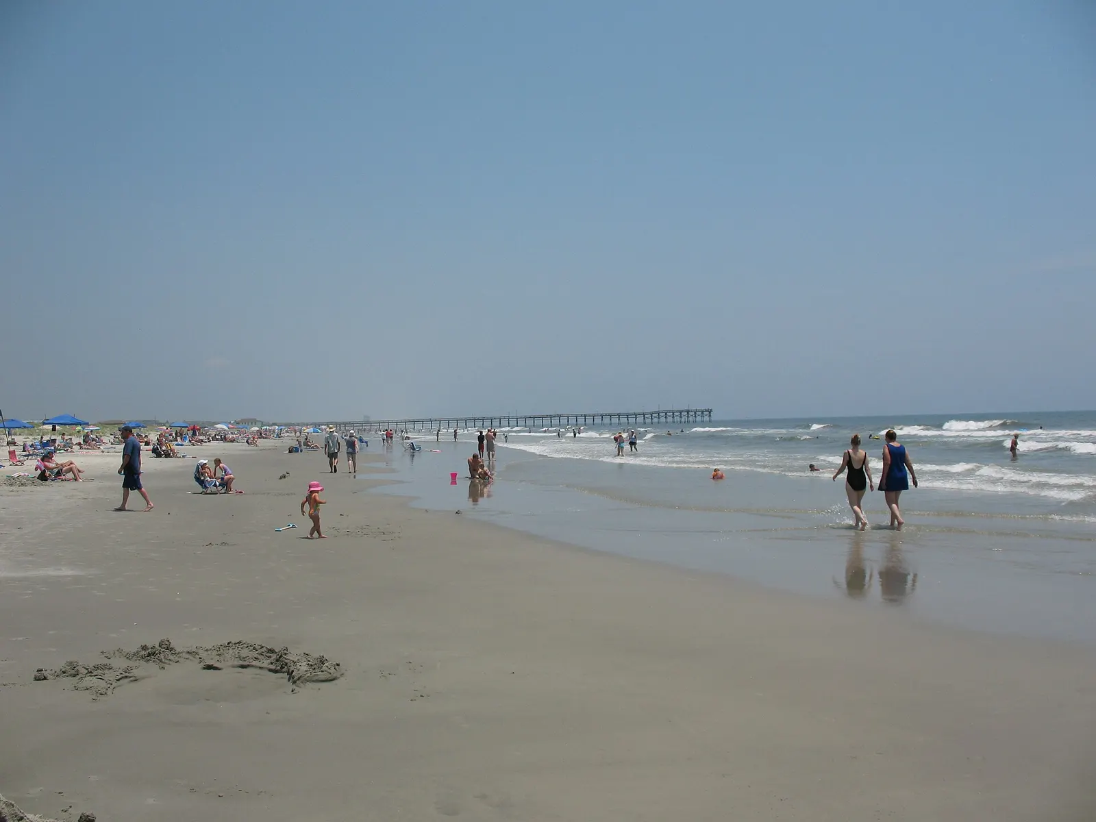 A wide, quiet Sunset Beach seen from the sand at the 36th Street access